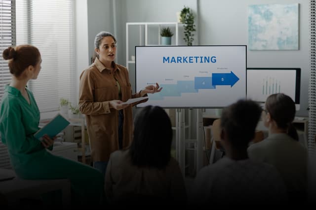 Tech Marketing Track: Woman presenting marketing strategy on screen with arrow and numbers