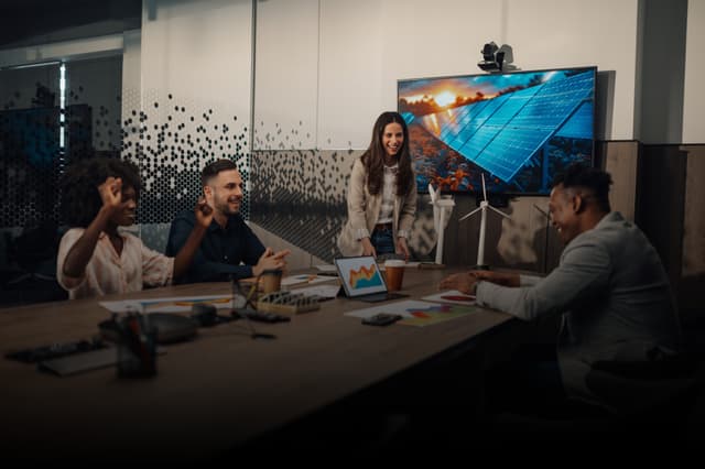 Human Resource Training: Two professionals standing and smiling in office environment