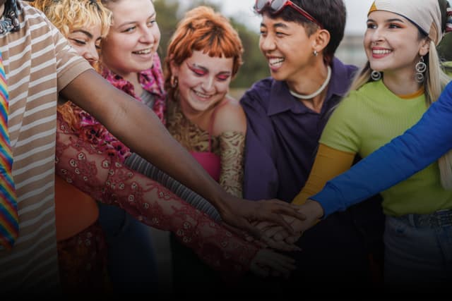 Sales & Development: Woman standing near whiteboard with charts, two people seated at table