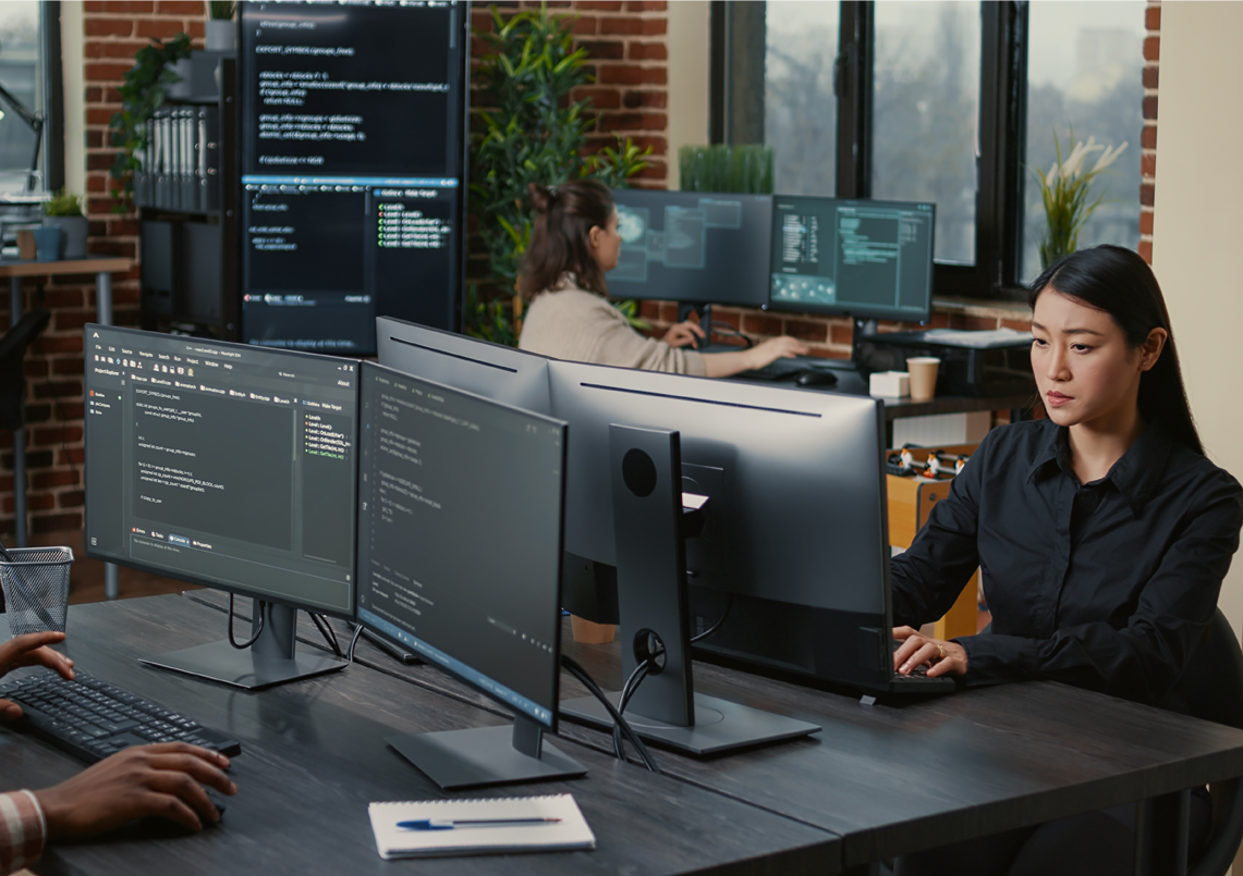 Group of diverse professionals sitting in office chairs with one woman smiling in front