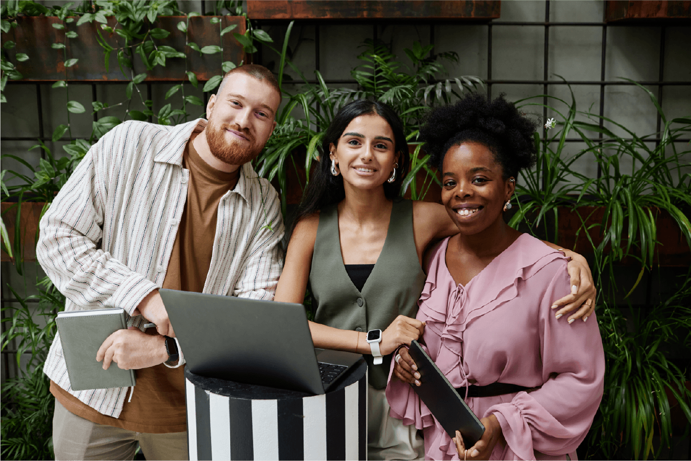 Group of diverse professionals sitting in office chairs with one woman smiling in front